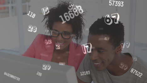 digital composition of multiple changing numbers floating against man and woman using computer