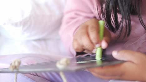child drawing on a small chalkboard