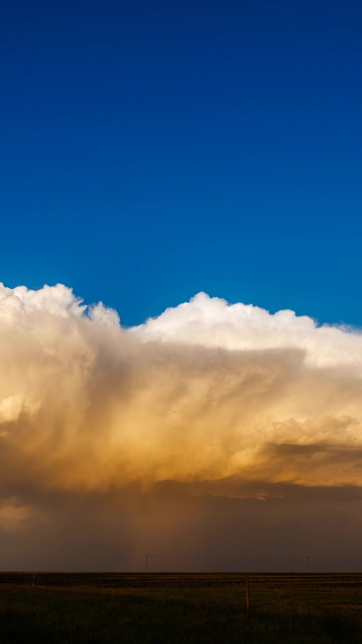 Golden hour clouds drifting across a glowing sunset sky at dusk