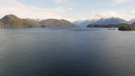 a drone rising over the water on the west coast of canada in bc