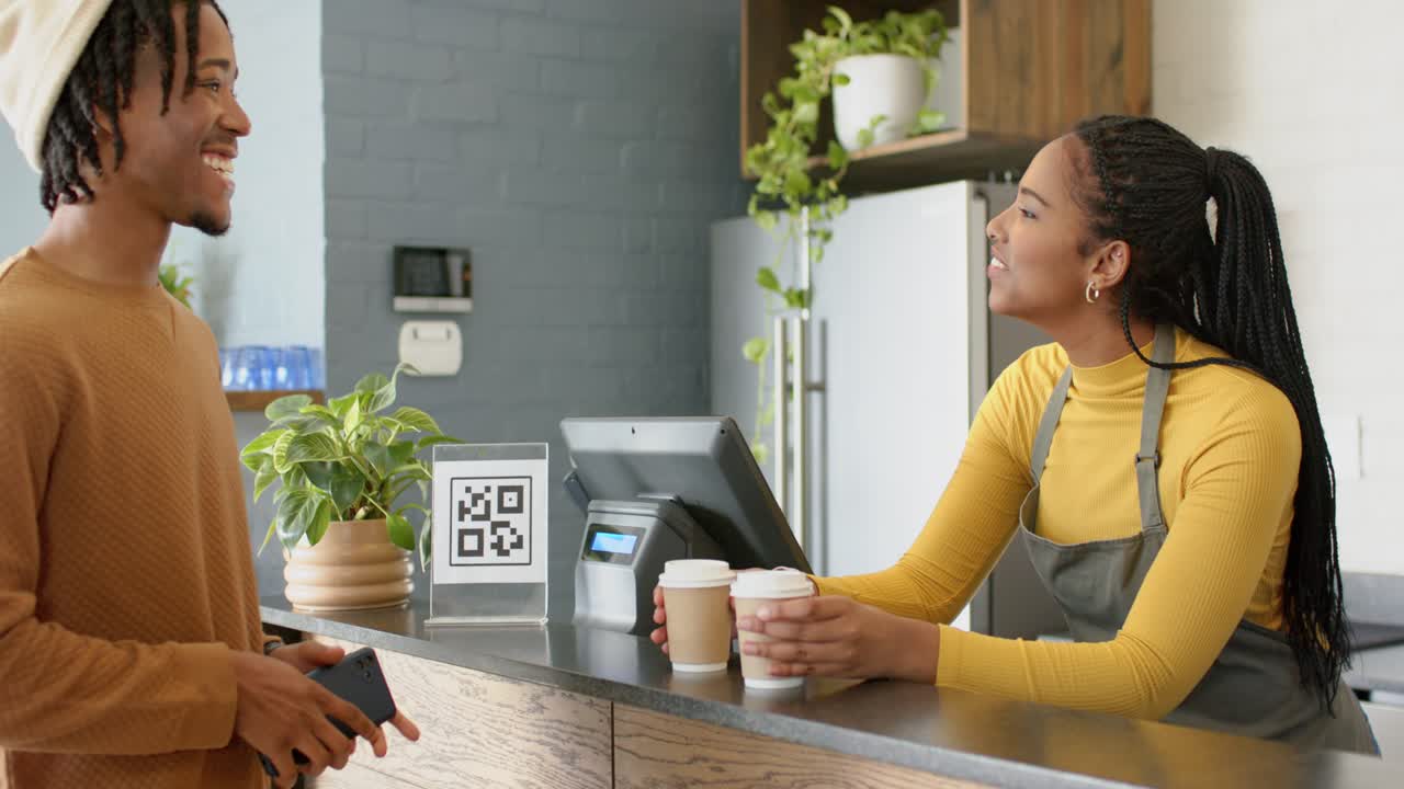 Scanning QR code, man confirming payment for coffee and receiving cups at counter, copy space
