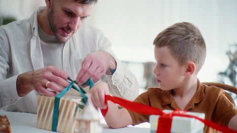 close-up of boy wrapping presents