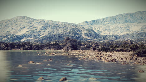 a serene landscape with a lake and mountains