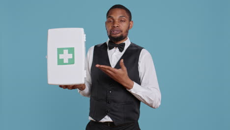 Hotel-porter-employee-presenting-a-first-aid-kit-used-for-medical-emergencies