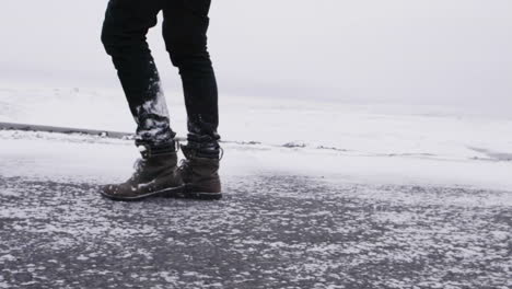 young male traveler walking through blizzard in slow motion