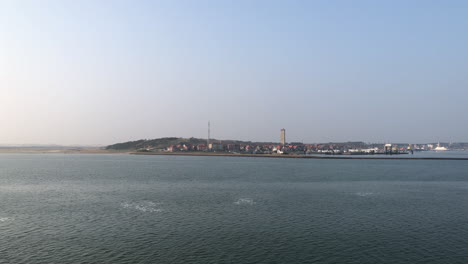 Aerial-shot-of-the-island-of-the-Dutch-Terschelling-in-the-Netherlands-with-iconic-lighthouse-landmark-named-Brandaris