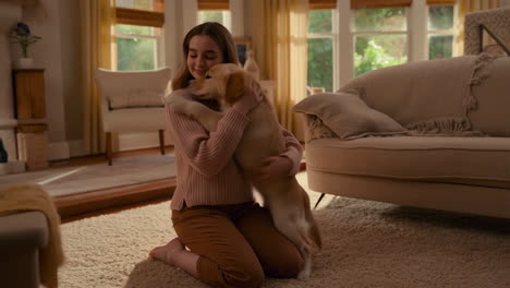 heartwarming hug between a girl and her golden retriever puppy