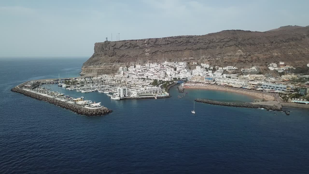 Captured from a drone, the beautiful Puerto de Mogán coastline stretches along the blue waters of the Atlantic.