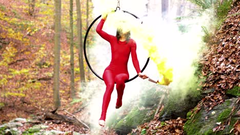 young woman doing aerial hoop dance outdoors