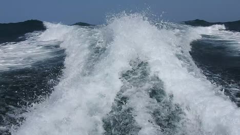 wake of water seen from behind of fast moving motor boat in a clear sky day,blue sea , water surface.destination vacation travel tropical ocean sea.beautiful background .