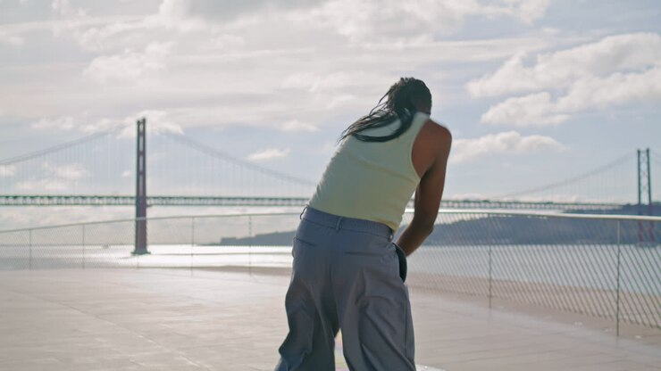 Focused man dancing ocean view vertical closeup. African american dancer moving