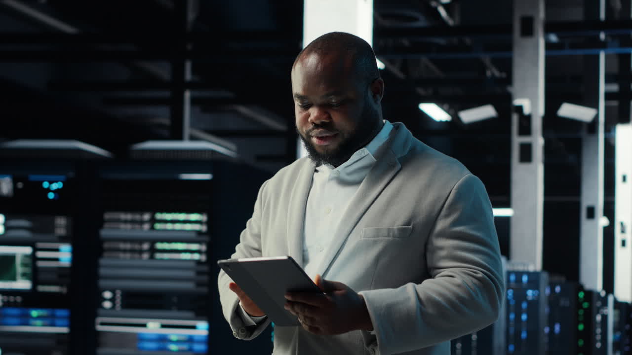 Vertical video IT professional looking over data center checkup checklist paperwork on tablet