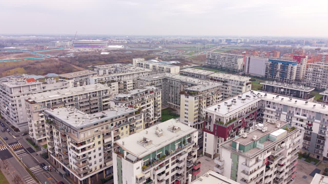 Một cảnh quan đô thị rộng lớn mở ra dưới bầu trời nhiều mây, thể hiện mạng lưới các tòa nhà và đường xá. Italy, Milan, Santa Giulia