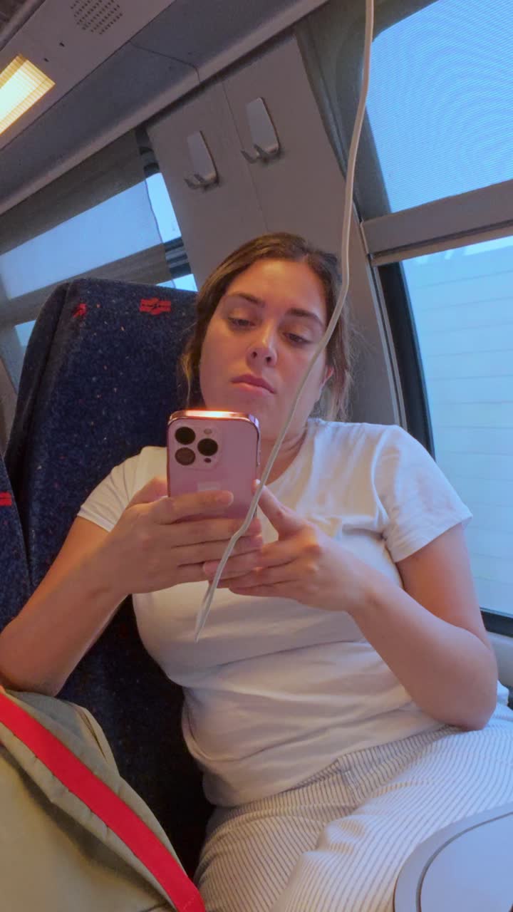 Modern Traveler Using Phone for Entertainment During a Commute