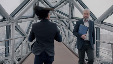 businessmen interacting on a city bridge
