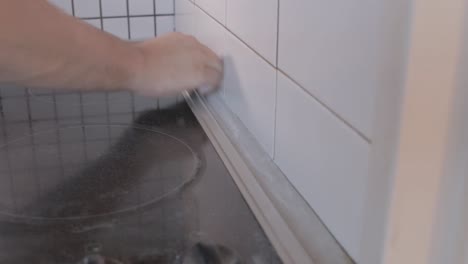 locked-off-shot-of-man-sanding-cupboard-with-sanding-paper