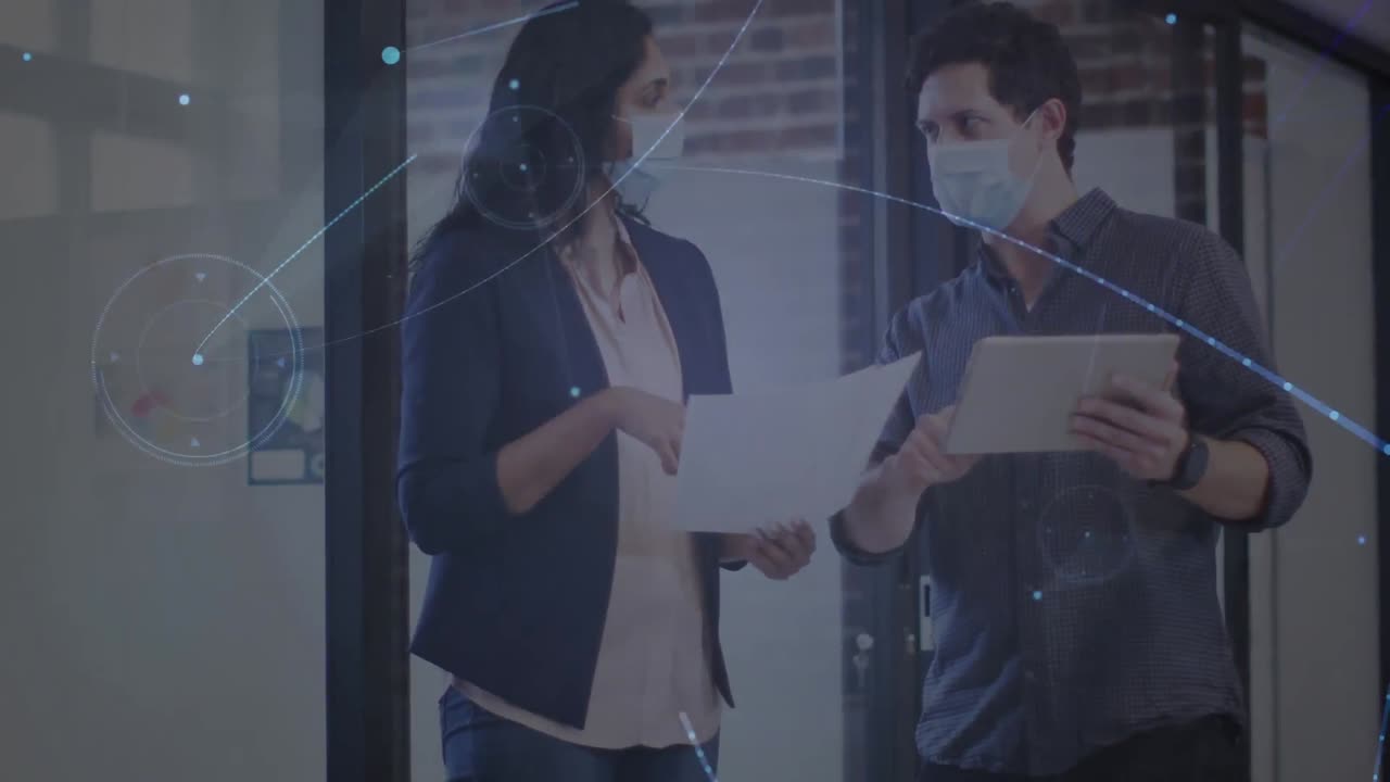 animación de una red brillante sobre un colega masculino y femenino con máscaras faciales hablando en la oficina