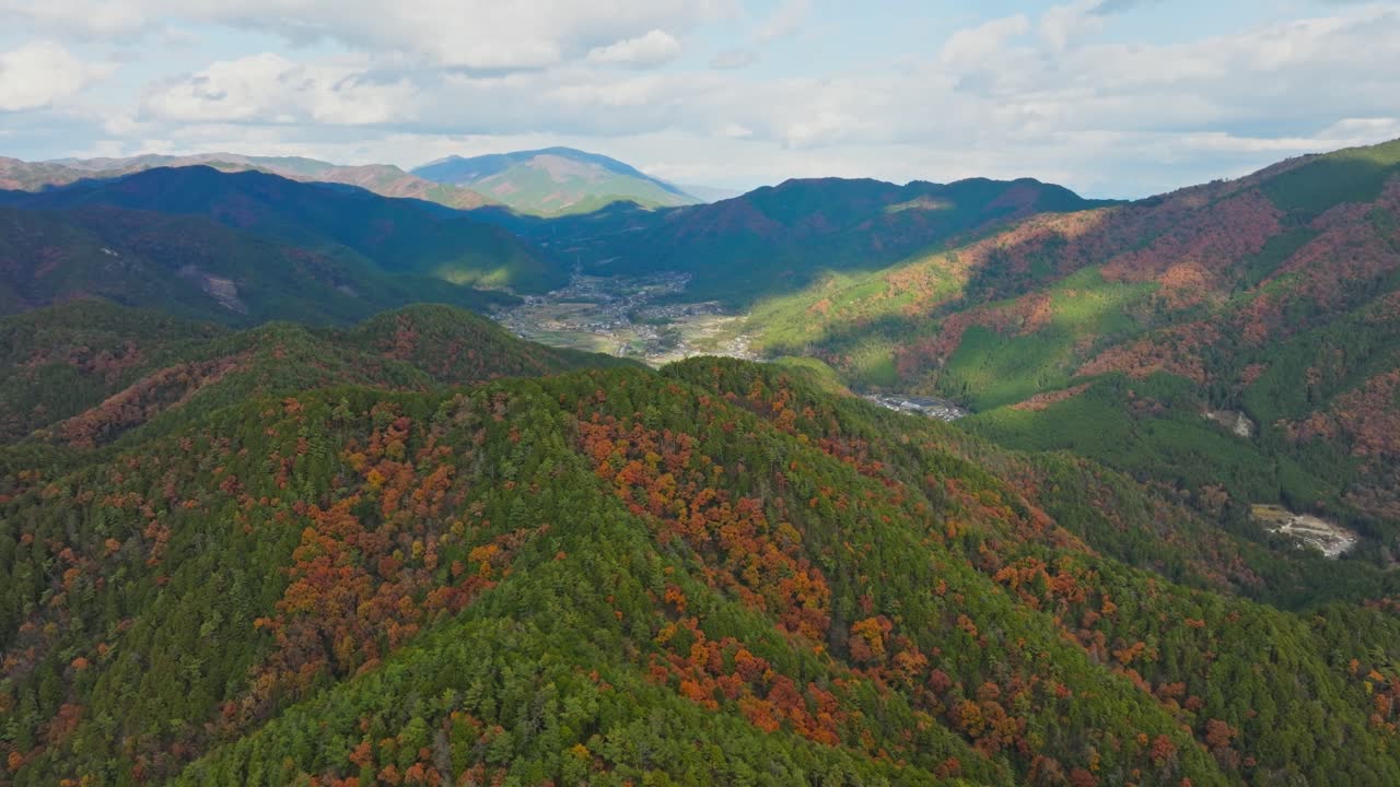 Autumn Forest and Mountain Cityscape in Kyoto, Japan, Aerial Drone Establishing view