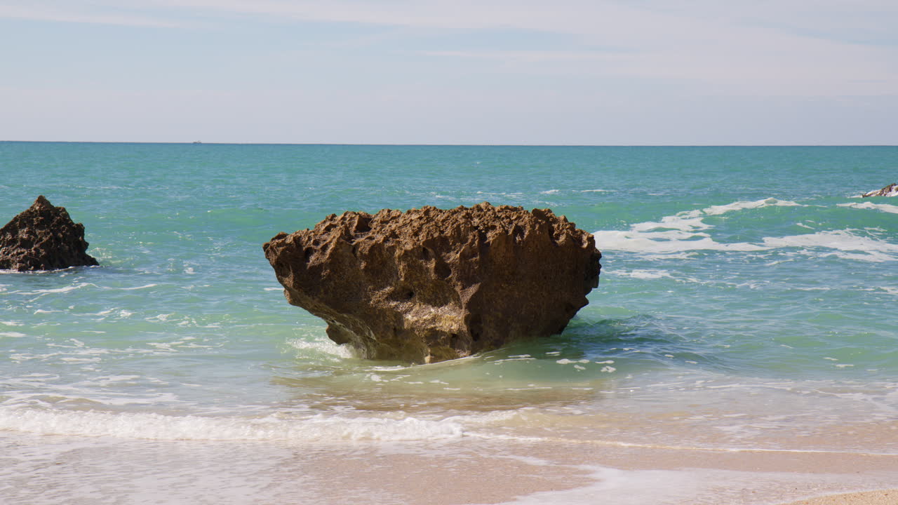 Sea Stack And Waves Of A Beach In Algarve, Portugal - wide