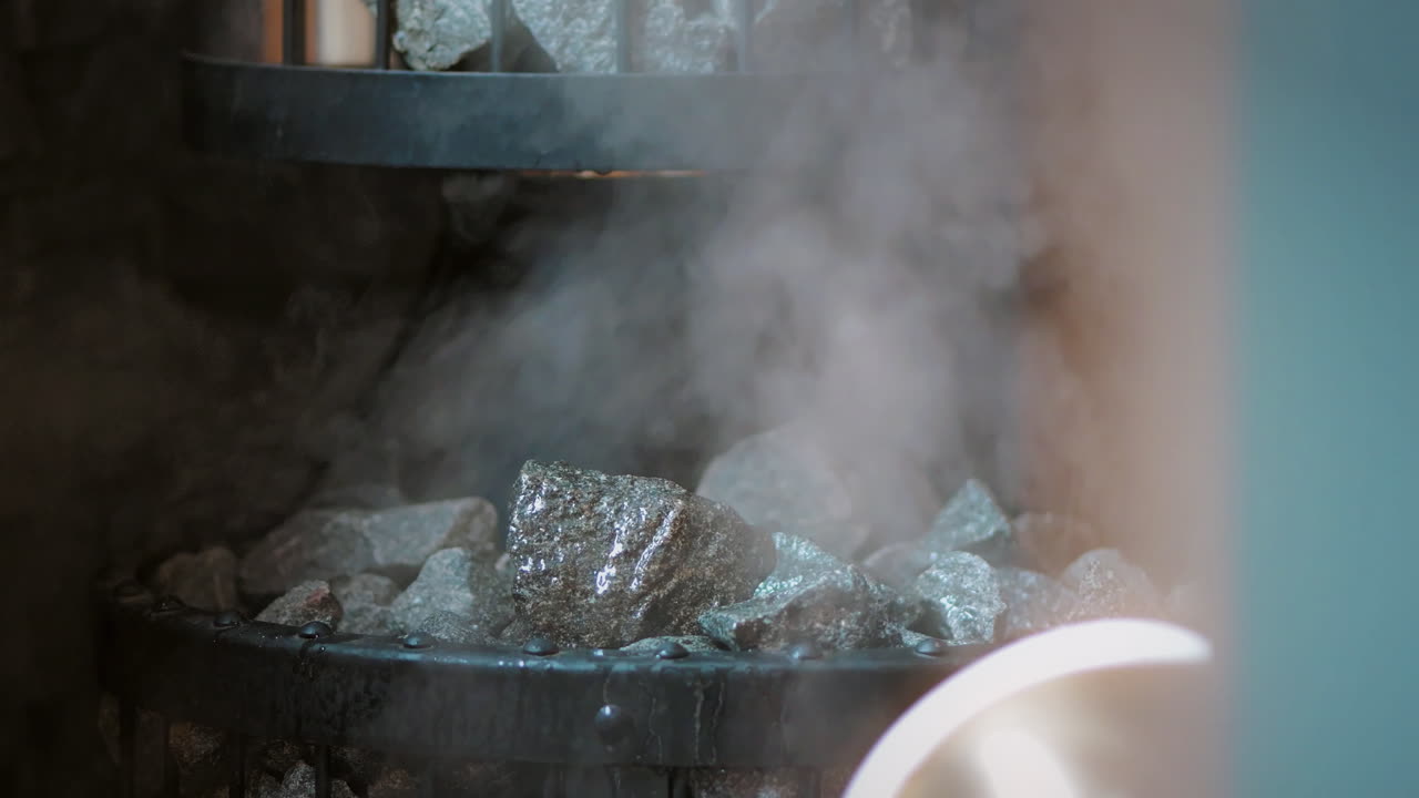 Heat and Steam in Sauna ,Pouring Water on Stones, Smoke, Close Up