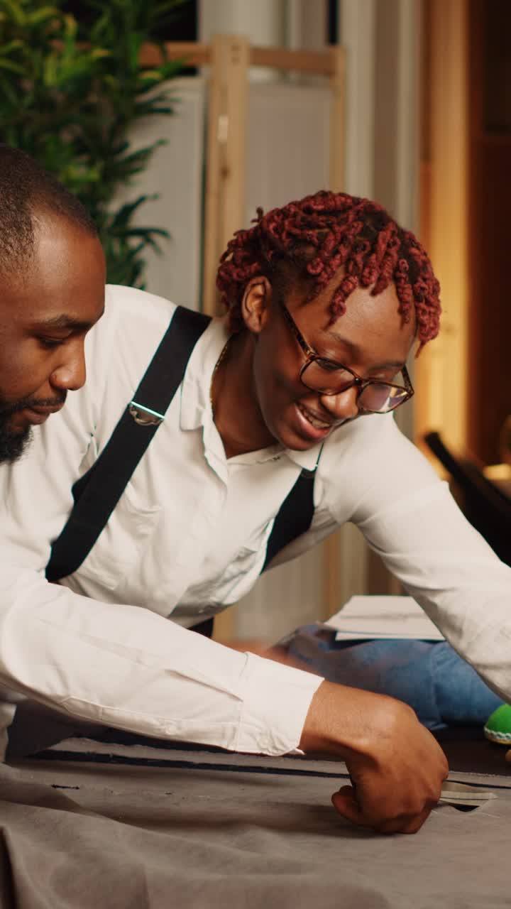 Vertical video Business partners cutting fabric
