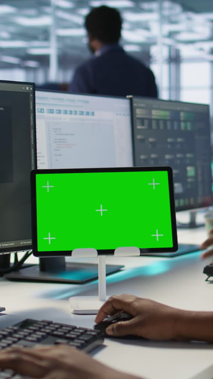 Vertical video Close up of coworkers coding on chroma key device in data center