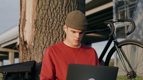 young man working on a laptop outdoors