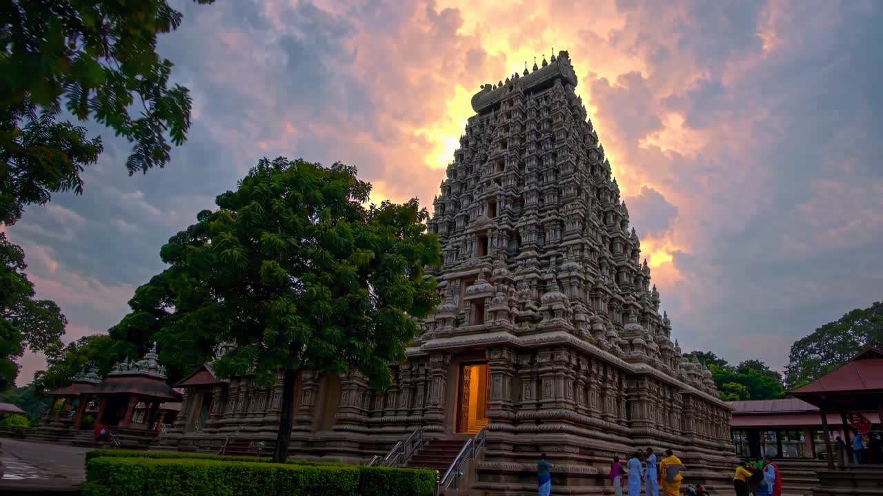 Low-angle shot of a majestic temple at sunset, with dramatic clouds