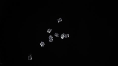 ice cubes launched upwards with a black background