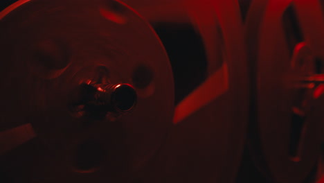 a close-up on a vintage tape recorder in a red blinking light