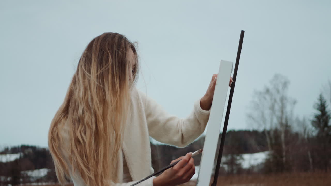 Woman Painting Outdoors in Winter