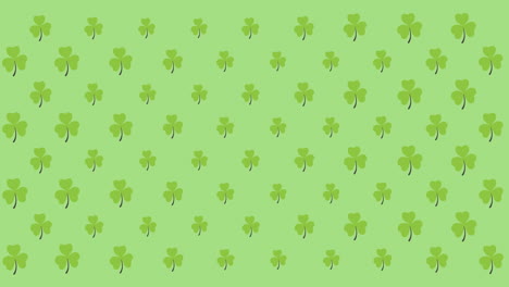 digital animation of multiple clover leaves moving against green background