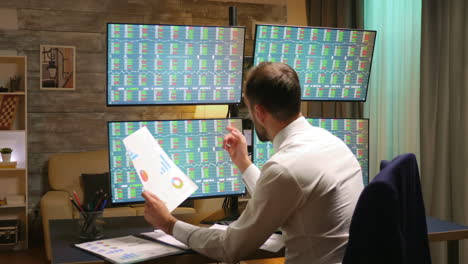 back view of stock market broker in home office