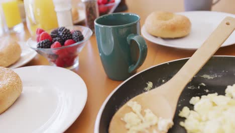 close up of fresh bread and fruit on breakfast with coffee and orange juice on table