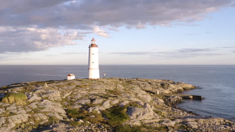 lille torungen lighthouse against cloudy sky in arendal, norway - aerial drone shot