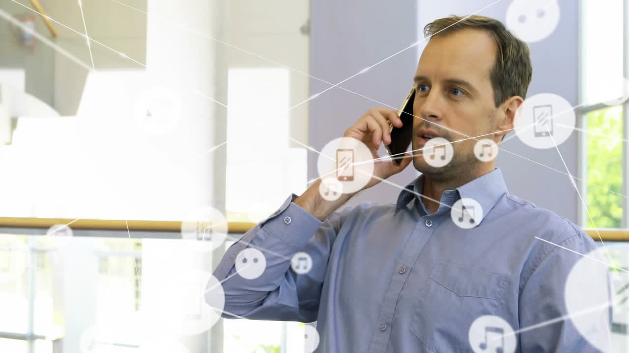 Office pro pausing typing, picking up phone and calling while tech data icons expanding around desk