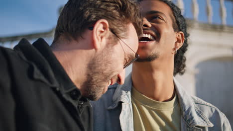 two men laughing outdoors