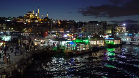 crowded area in istanbul during evening with ships at galata bridge