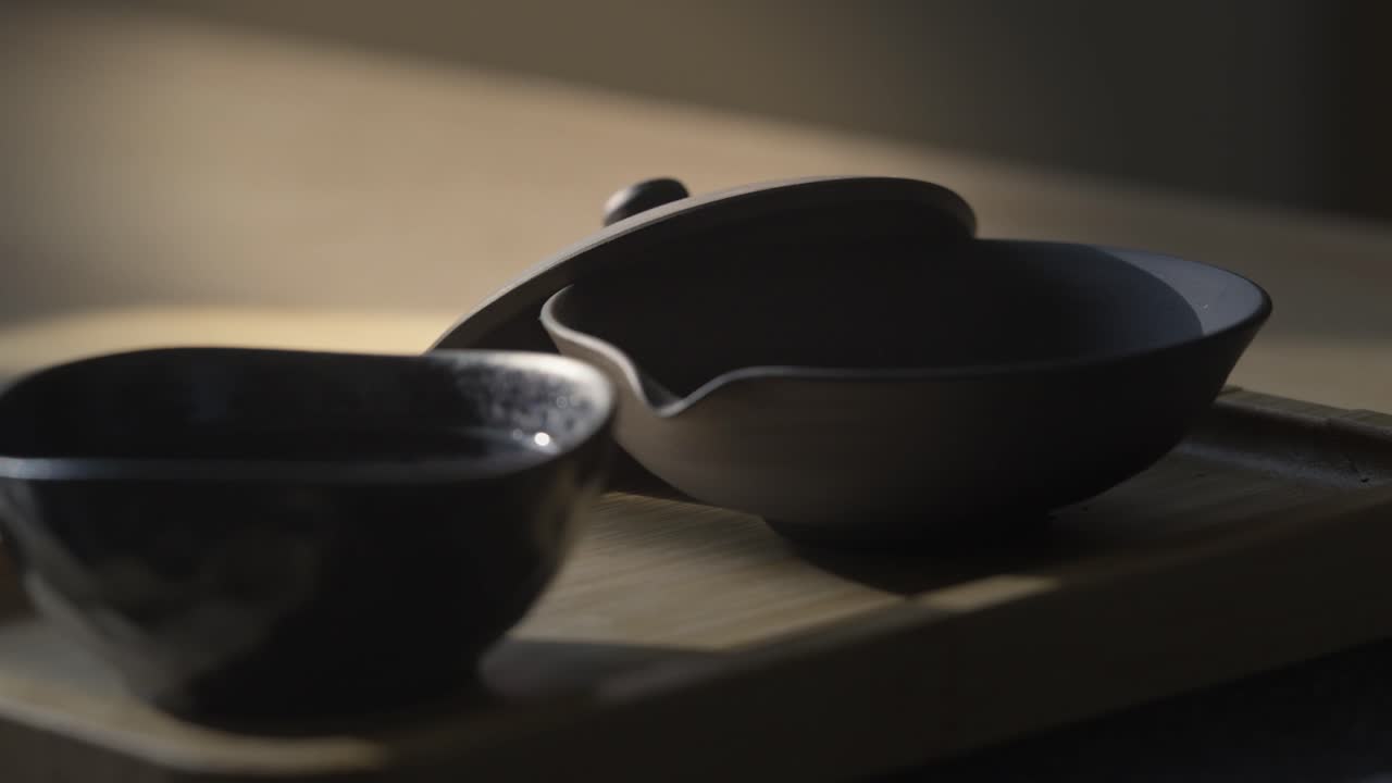 Pouring tea leaves into a Japanese shiboridashi to prepare delicious gyokura tea. A soothing home brewing ceremony