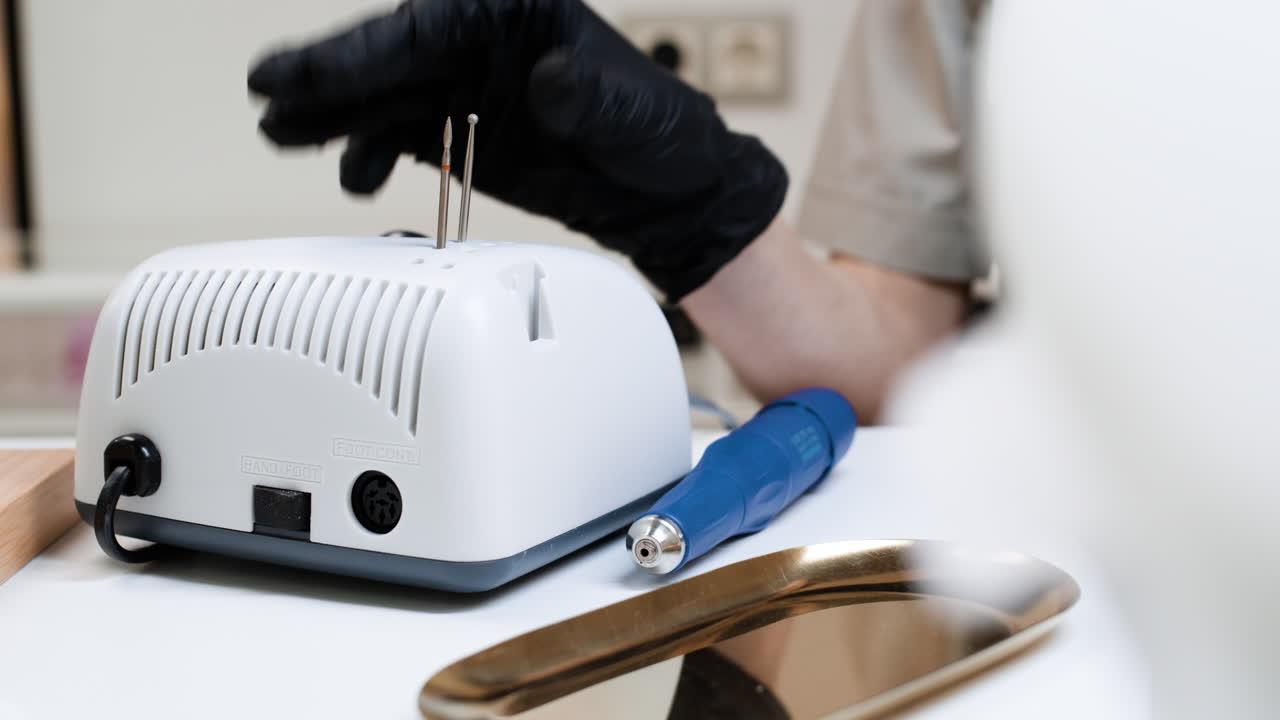 Nail Technician Using Electric Nail Drill