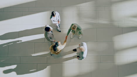 Above,-handshake-and-group-of-business-people