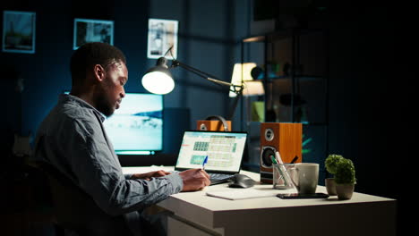 african american teleworker managing daily schedule and does post it memo notes