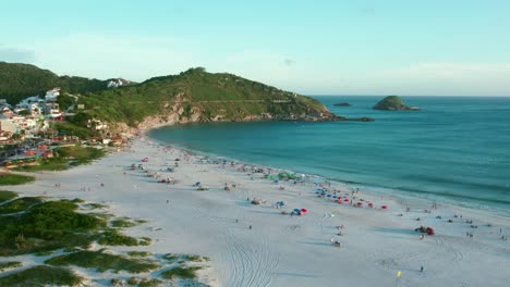 Arraial-do-Cabo-sunny-beach-resort-with-lush-green-hillside,-Rio-de-Janeiro,-Brazil-aerial-view