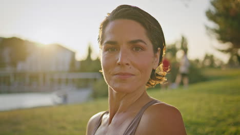 portrait smiling yoga woman posing sunlight park at morning. lady looking camera