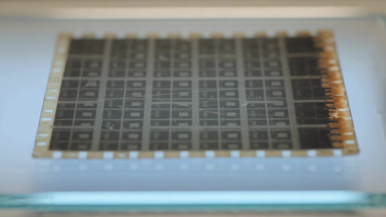 Focusing camera bringing test substrate into clearer view on light table to inspect oxidized pads