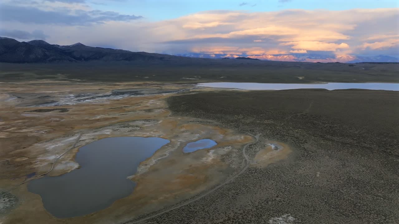 Hilltop Wild Willy's Hot Springs Mammoth Lakes California aerial drone winter vibrant sunset clouds Benton Crossing Lake Crowley Long Valley Caldera valley birds flying forward pan up motion
