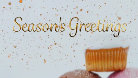 animation of christmas greetings over cupcakes on white background