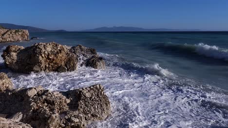 angry mediterranean sea waves splashing dramatically against rugged cliffs - a spectacular display of elemental power, nature's fury