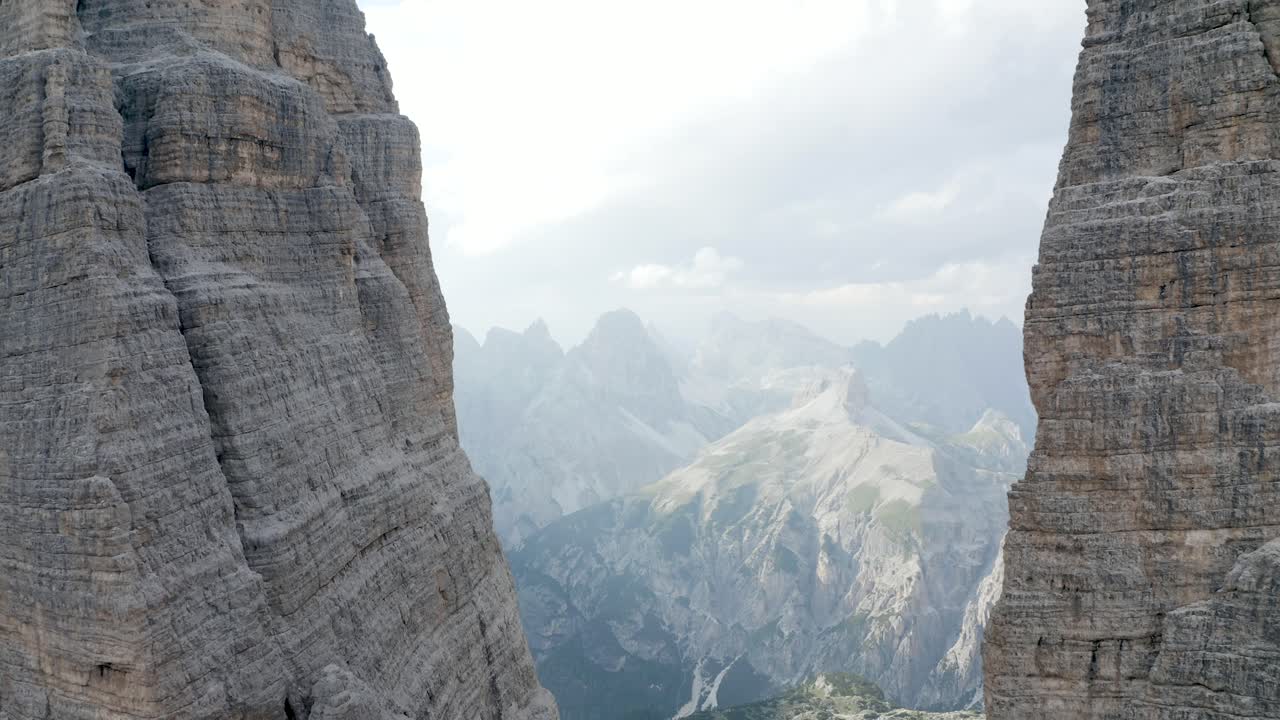 Closeup Aerial of flying in between 2 cliffs in the mountains, Tre cime die Lavaredo, Dolomiti, Italia