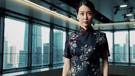 professional asian woman in traditional cheongsam in a modern office
